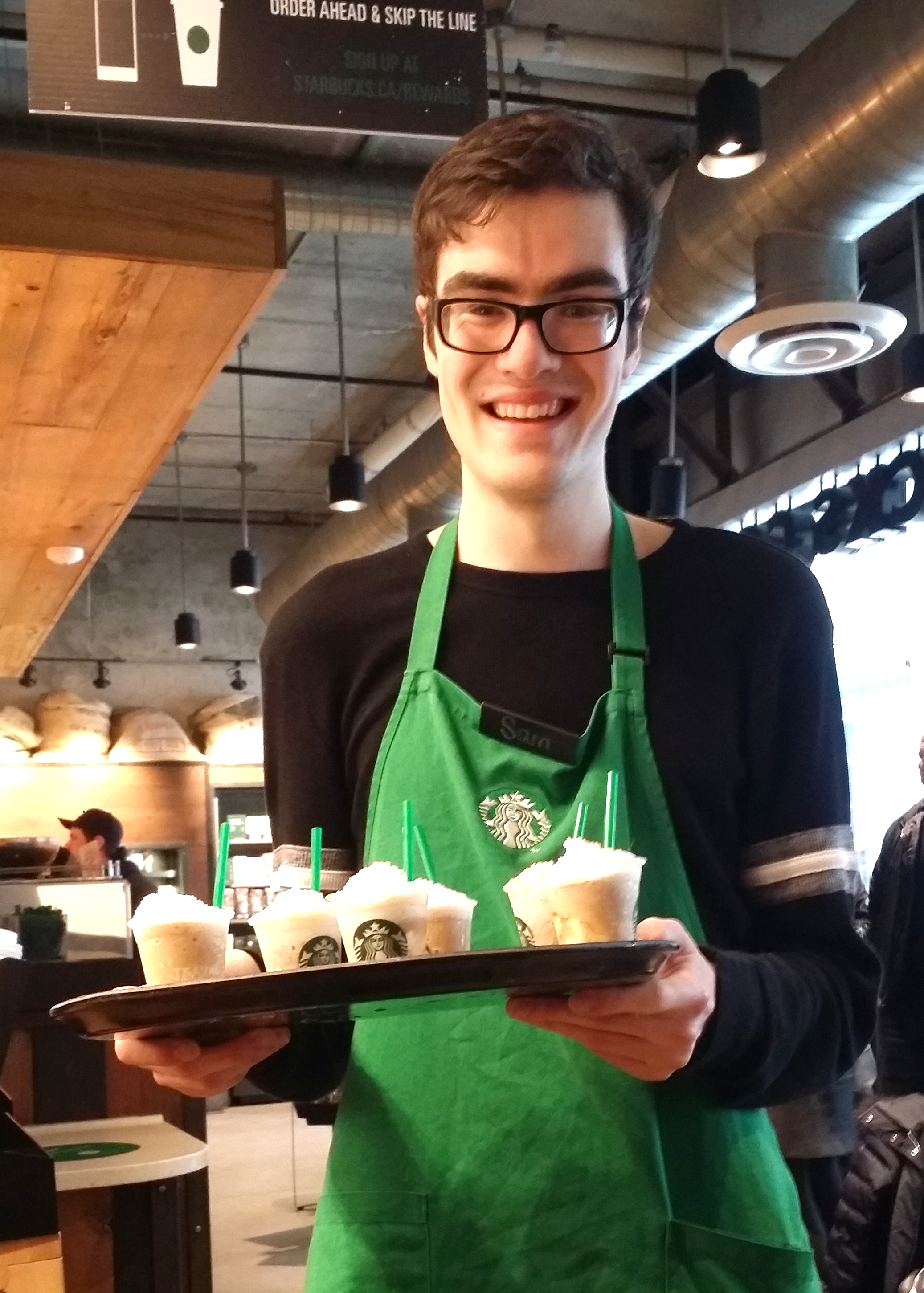 Sam serving drinks at Starbucks.