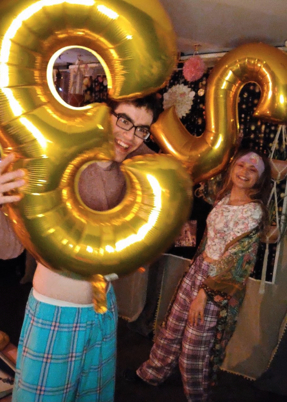 Sam holding his birthday balloons.