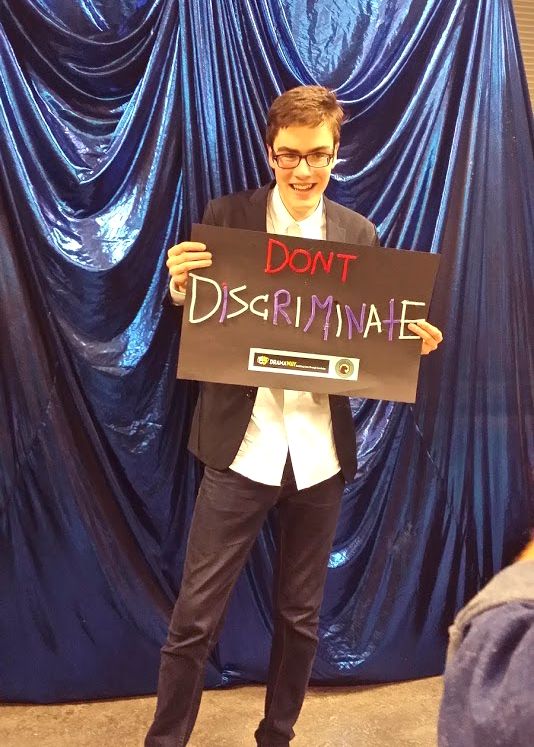 Sam holding a sign.