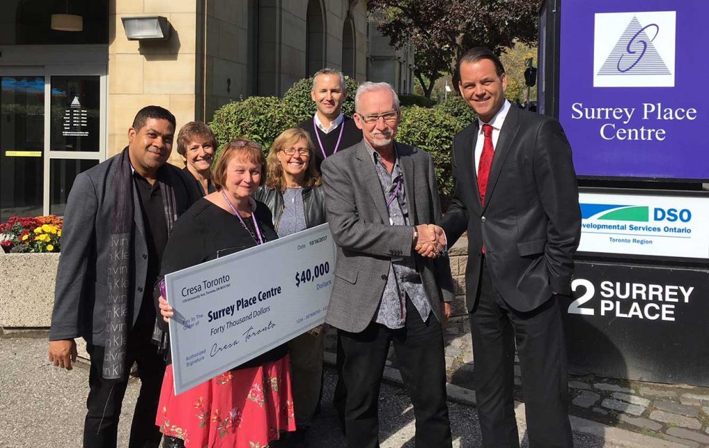 Surrey Place staff receives donation from Cresa. 
