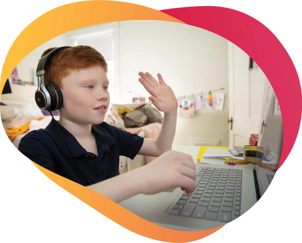 Child with autism waves at a computer screen in a virtual aba therapy service in Toronto or Ontario
